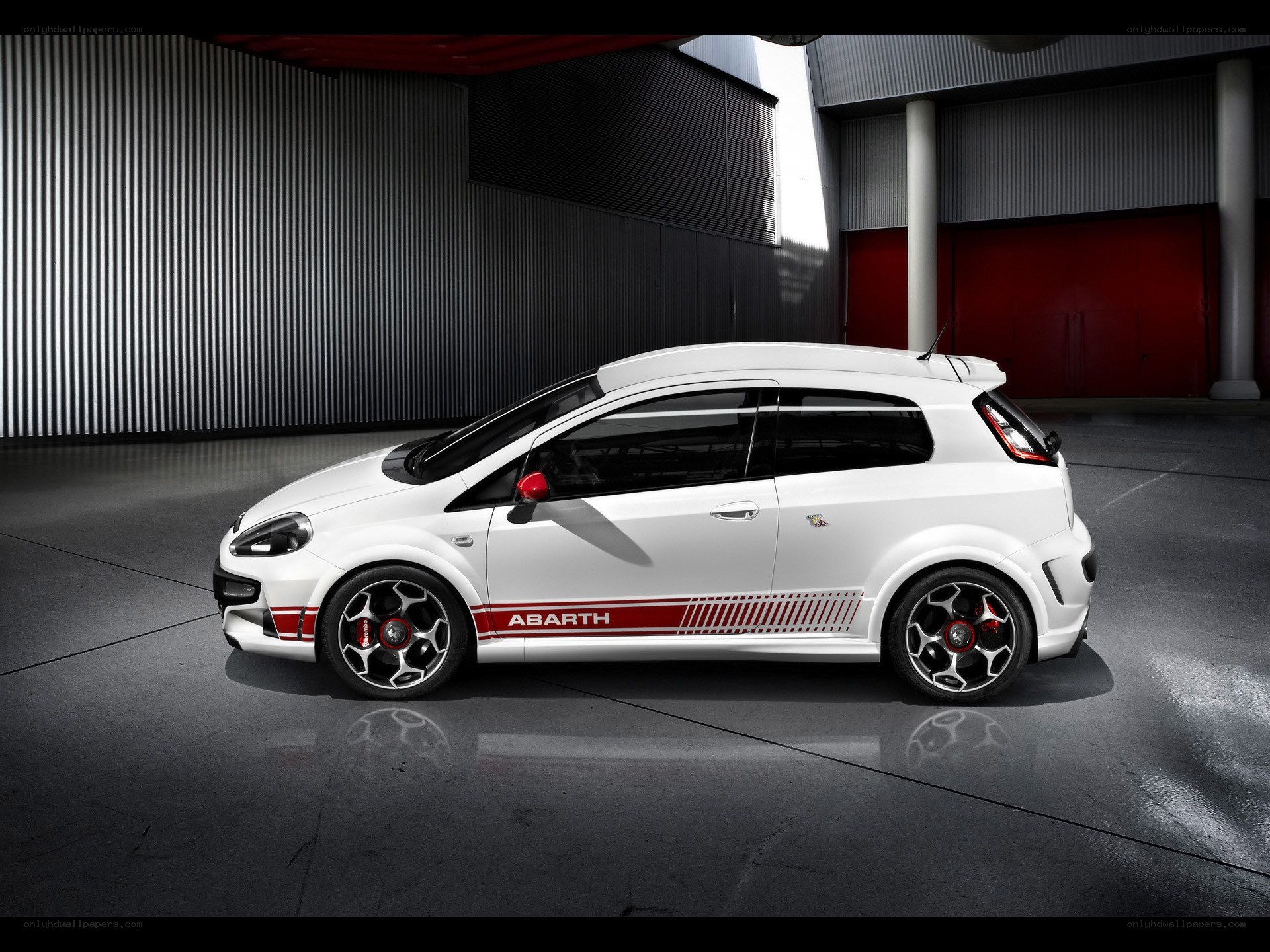 White Abarth car in garage