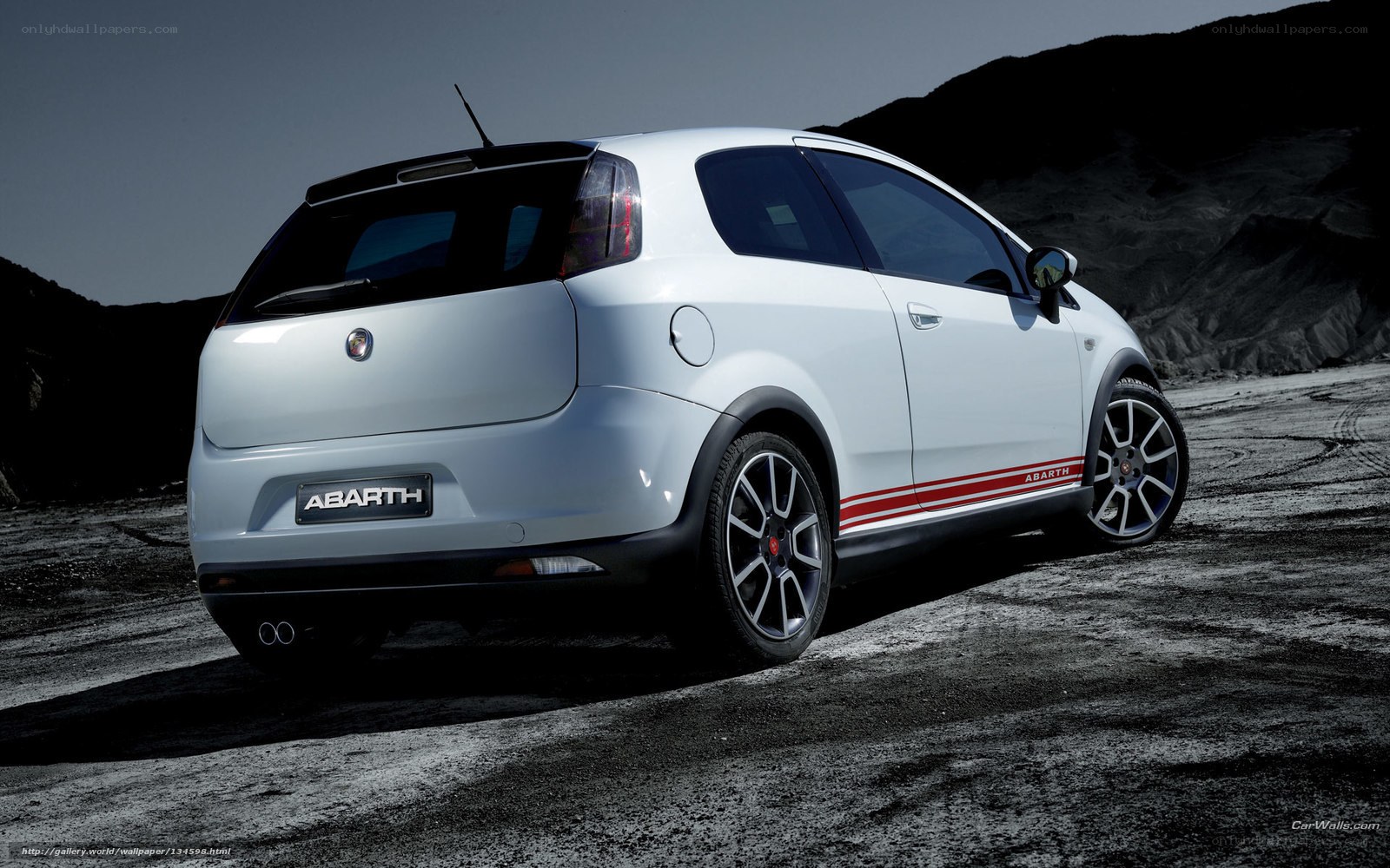 white abarth car on dirt