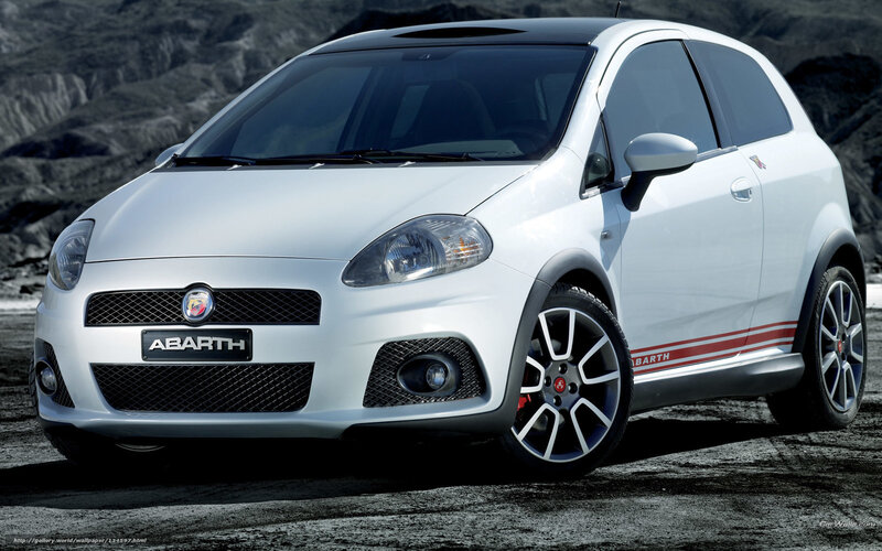 white abarth car on rocky terrain