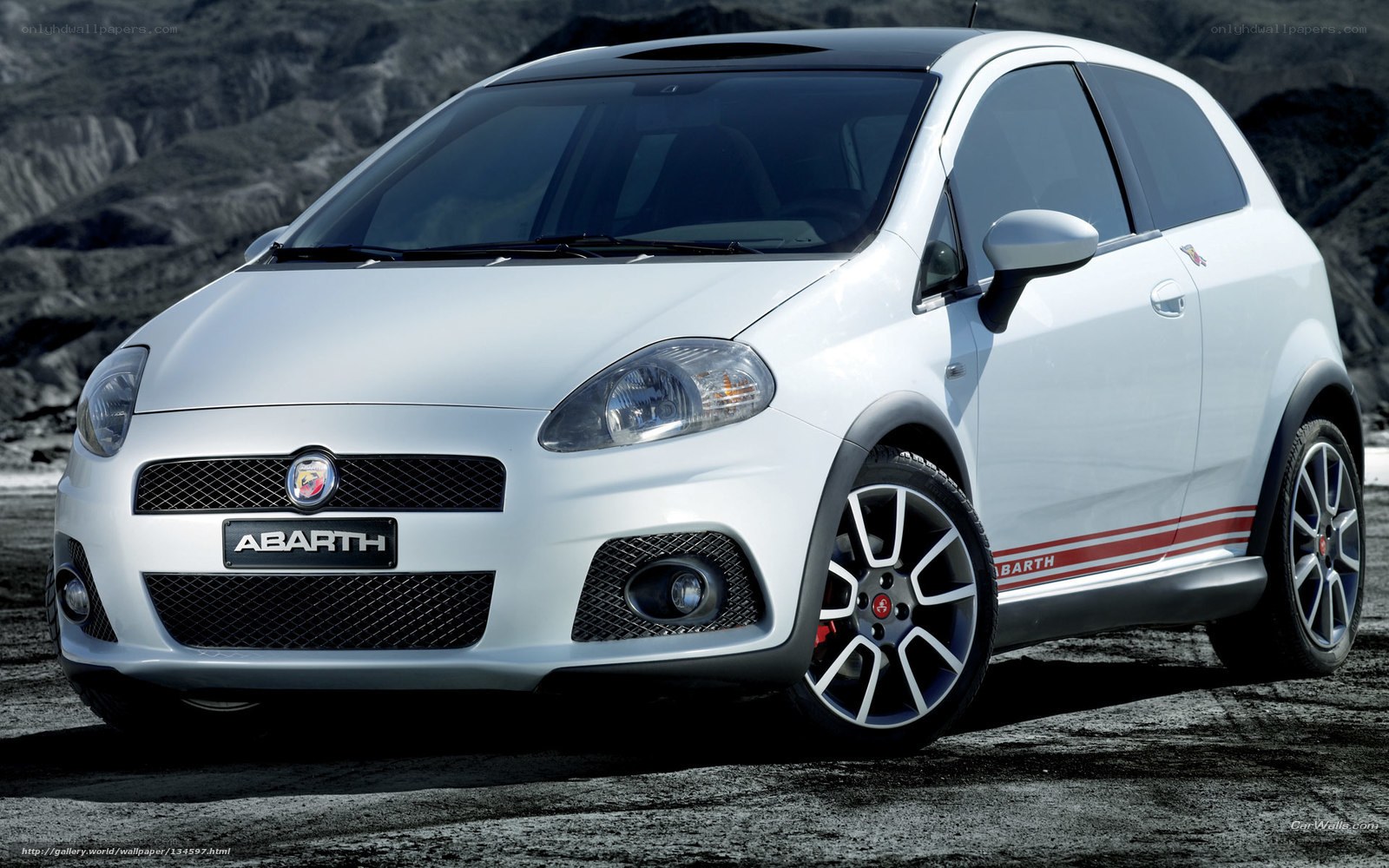 white abarth car on rocky terrain
