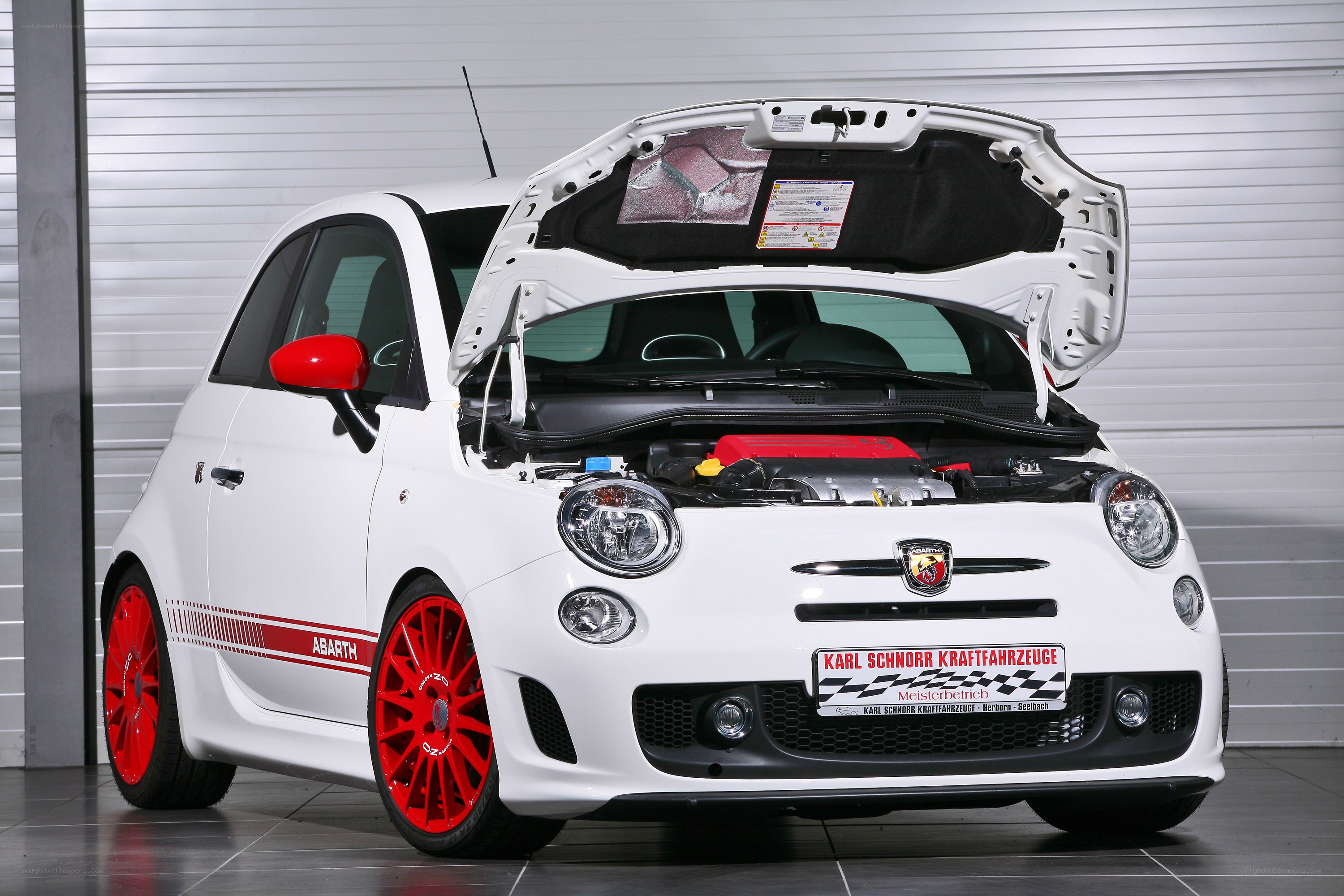 White Abarth car with open hood