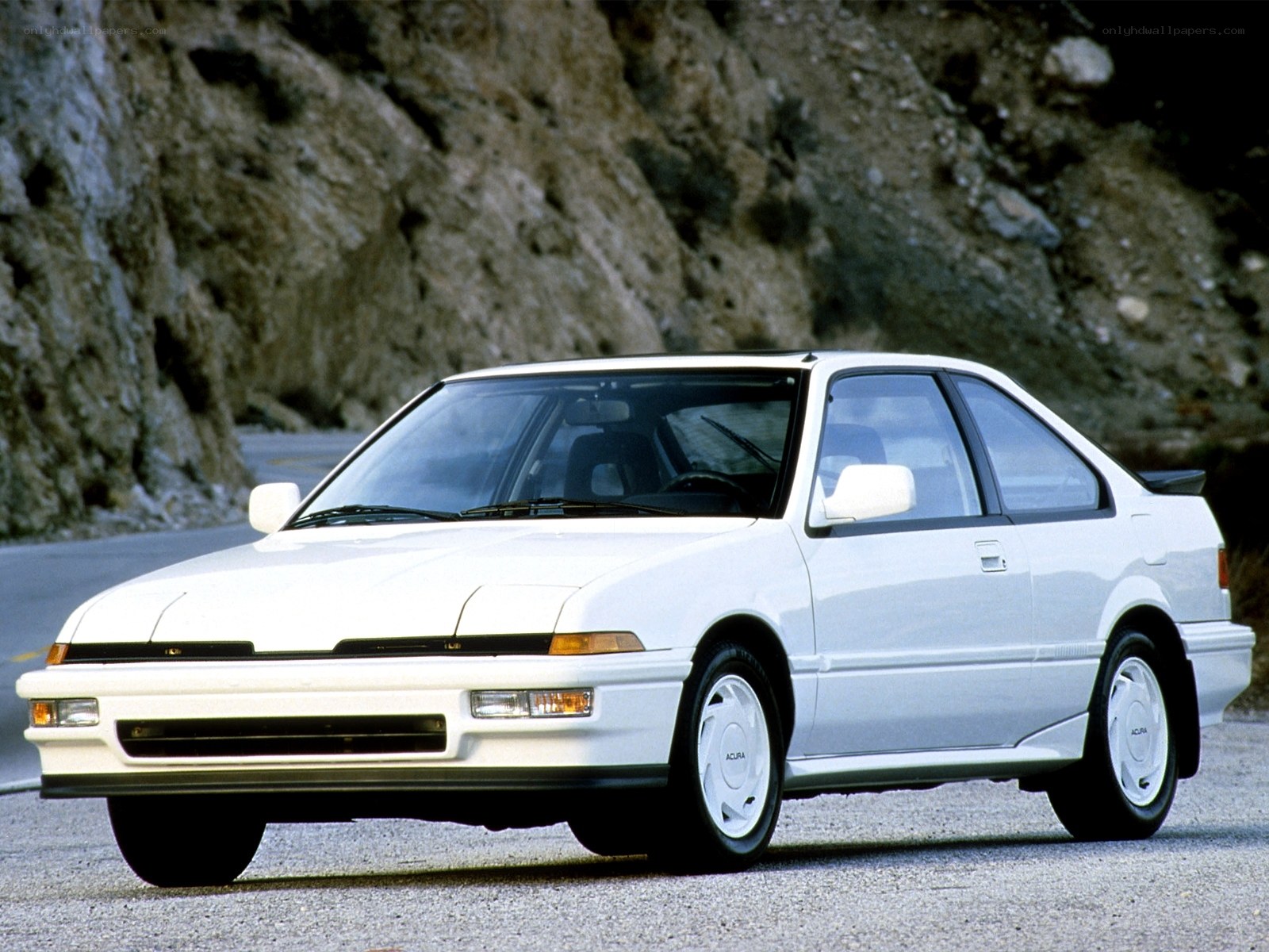 white acura coupe on road