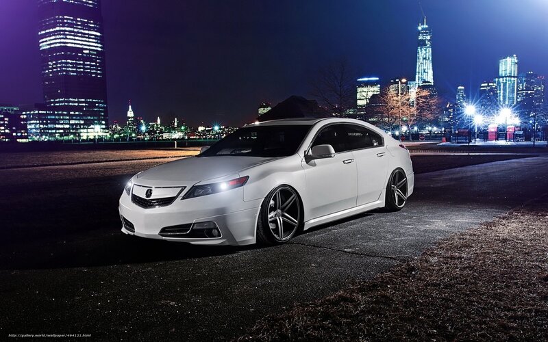 White Acura in city at night