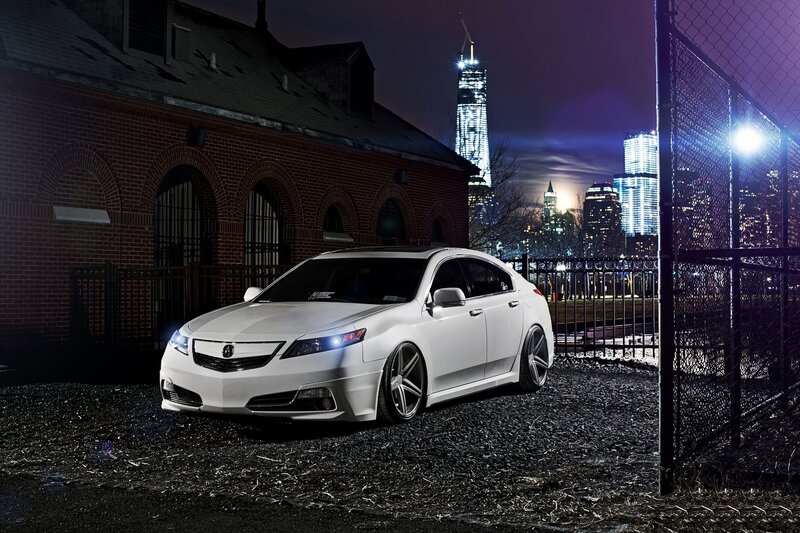White Acura in urban night scene