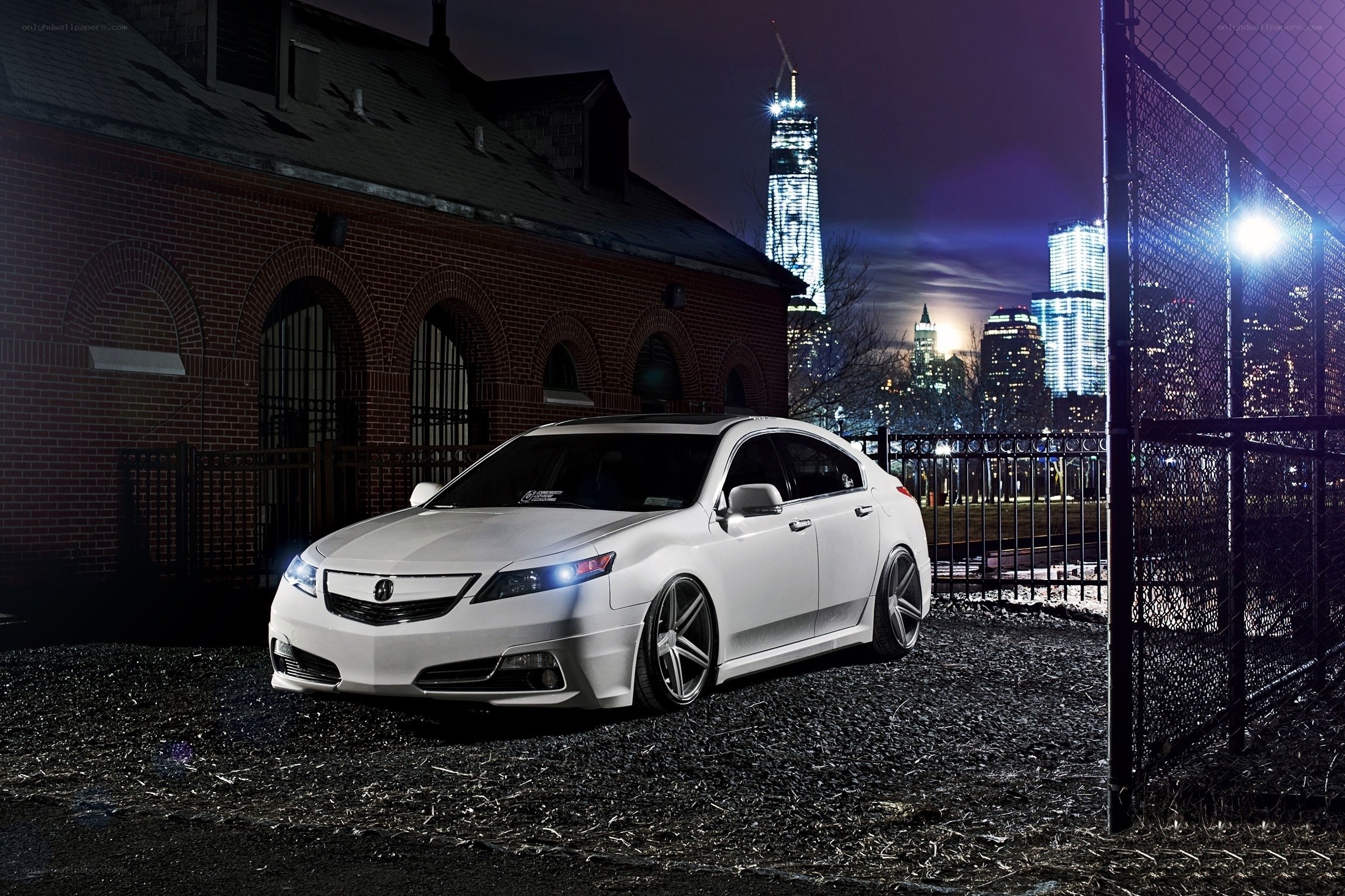 White Acura in urban night scene