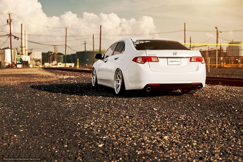 White Acura on gravel lot