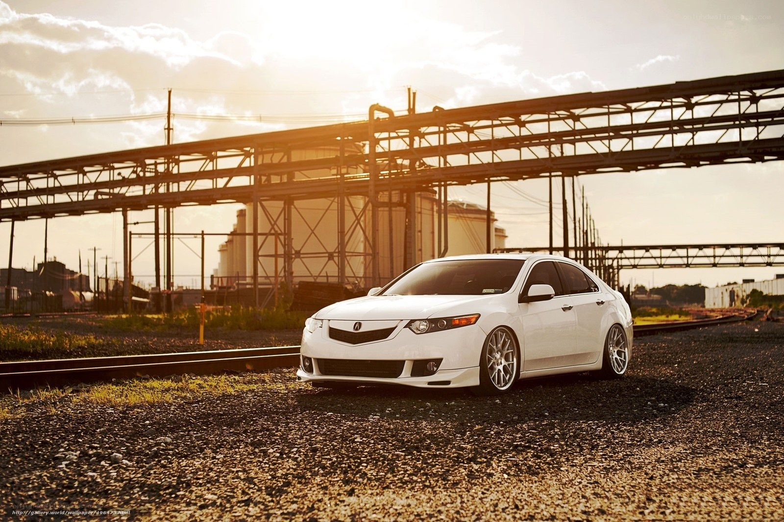 White Acura on train tracks