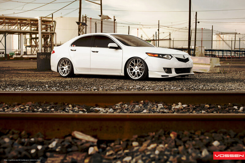 white acura sedan on train tracks