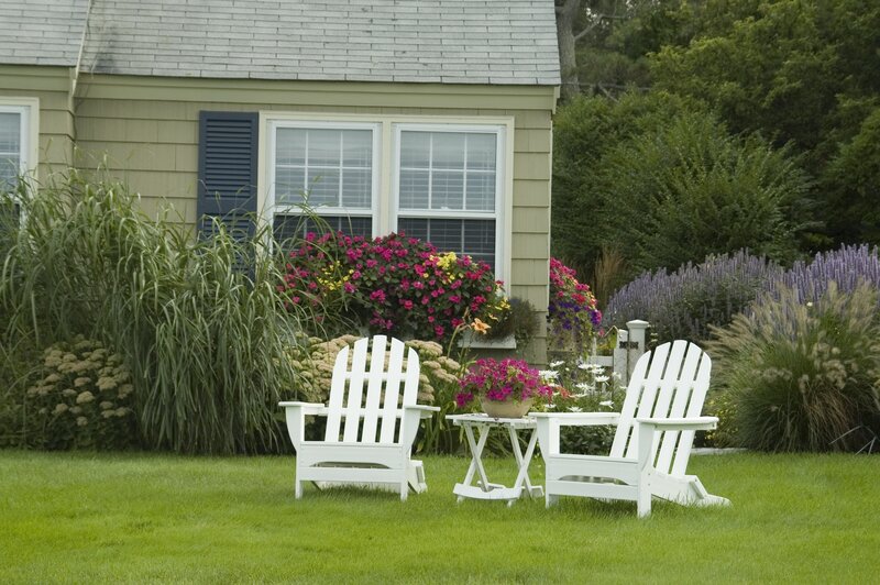 White Adirondack chairs in garden