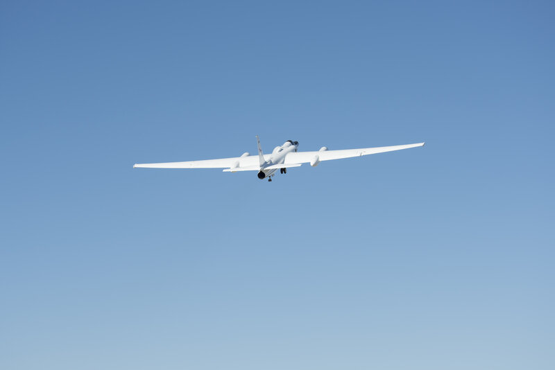 White Aircraft in Flight — Blue