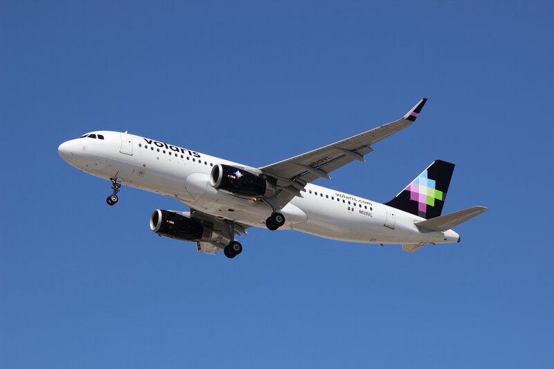 White Airplane in Flight — Blue, Clear, Afternoon