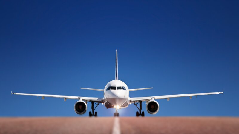 White Airplane on Runway — Blue