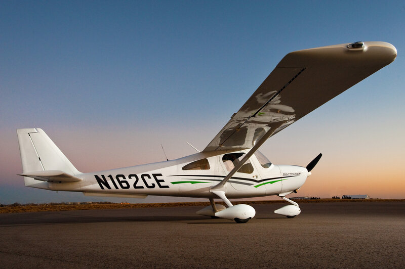 White airplane on tarmac at sunset