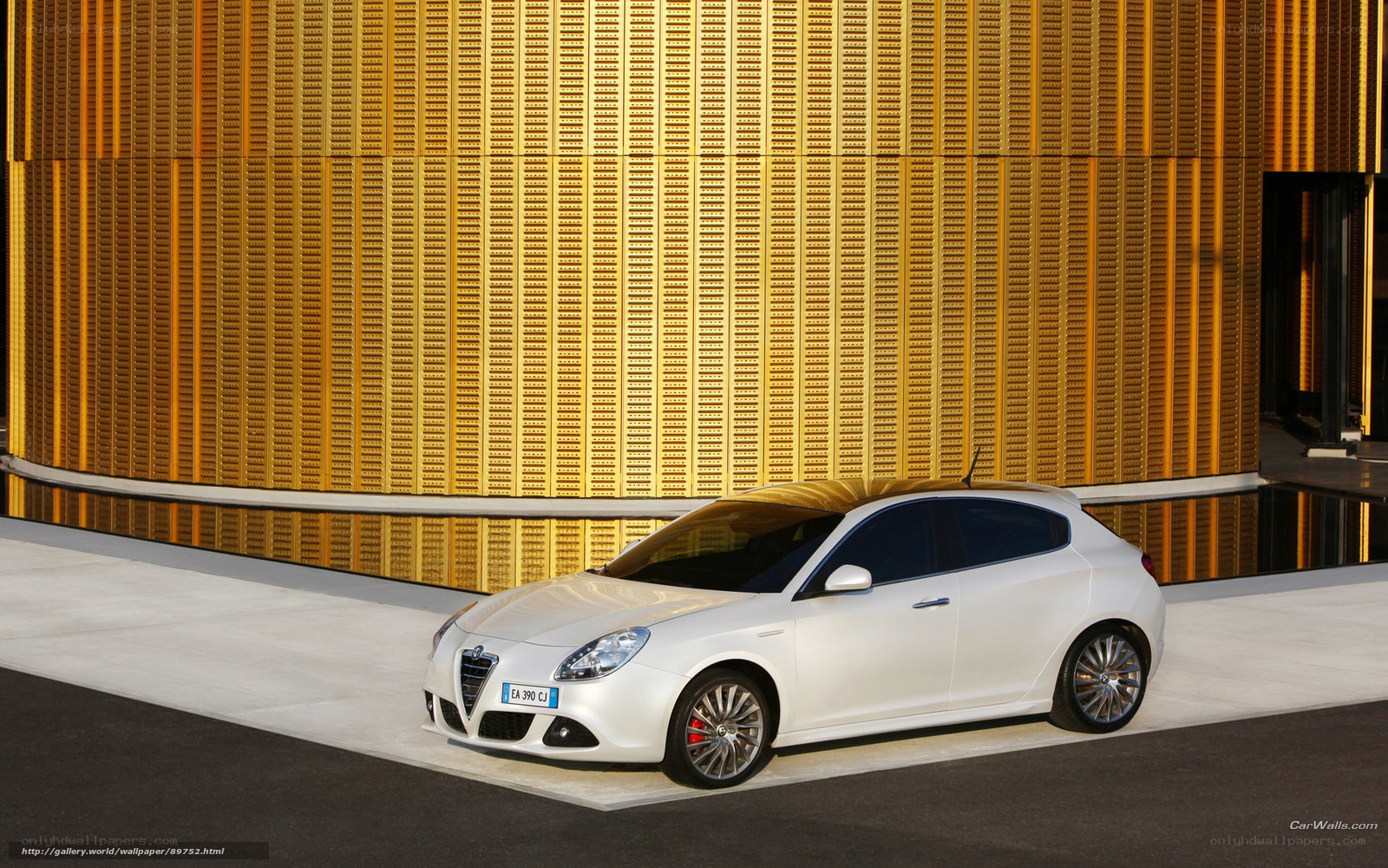 White Alfa Romeo car in front of golden wall