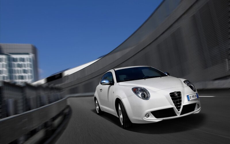 White Alfa Romeo driving on highway