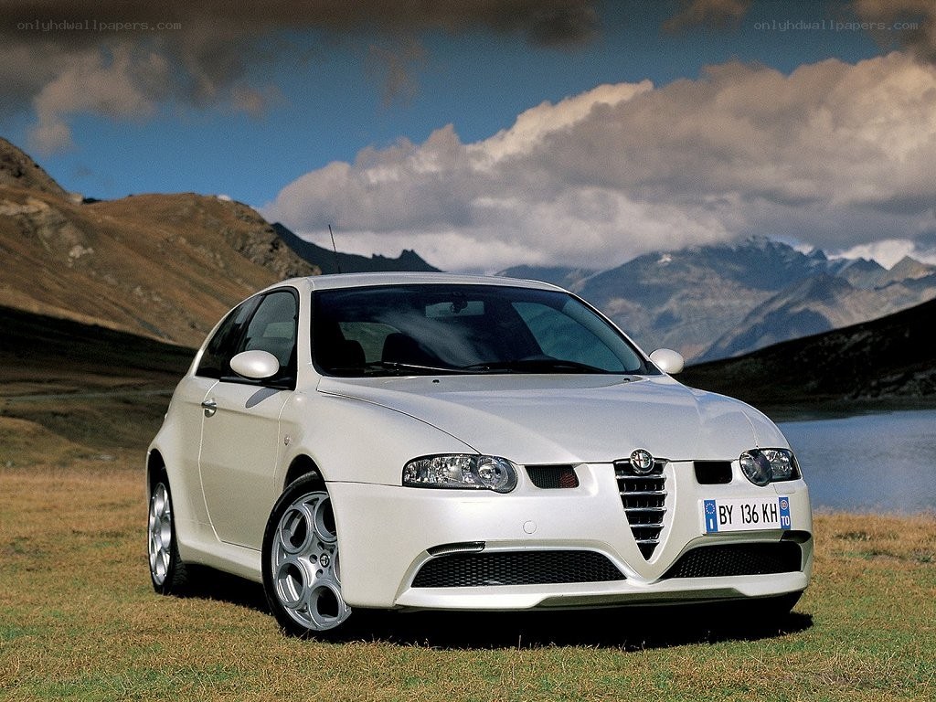 white alfa romeo in mountain landscape