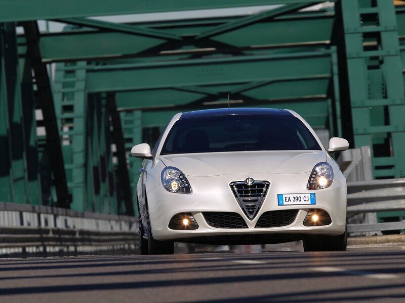 white alfa Romeo on a bridge