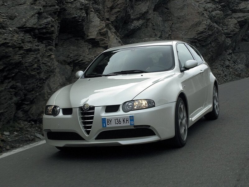 white alfa romeo on mountain road