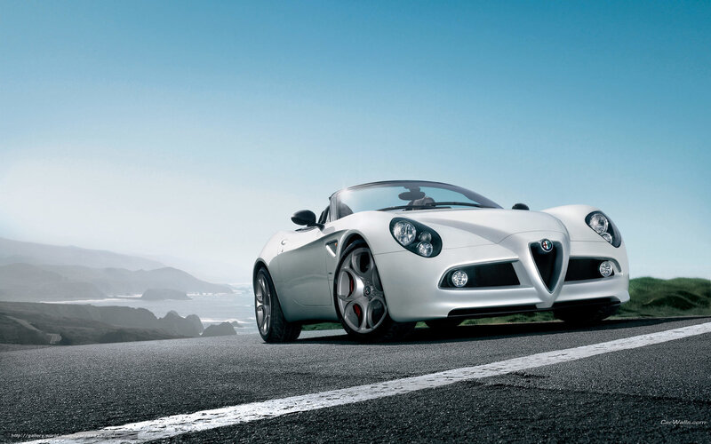White Alfa Romeo Spider on coastal road