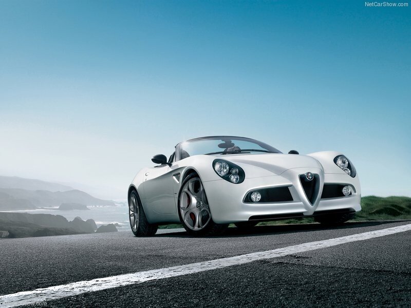White Alfa Romeo Spider on coastal road
