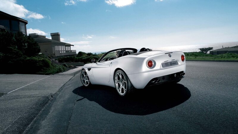 White Alfa Romeo Spider on coastal road