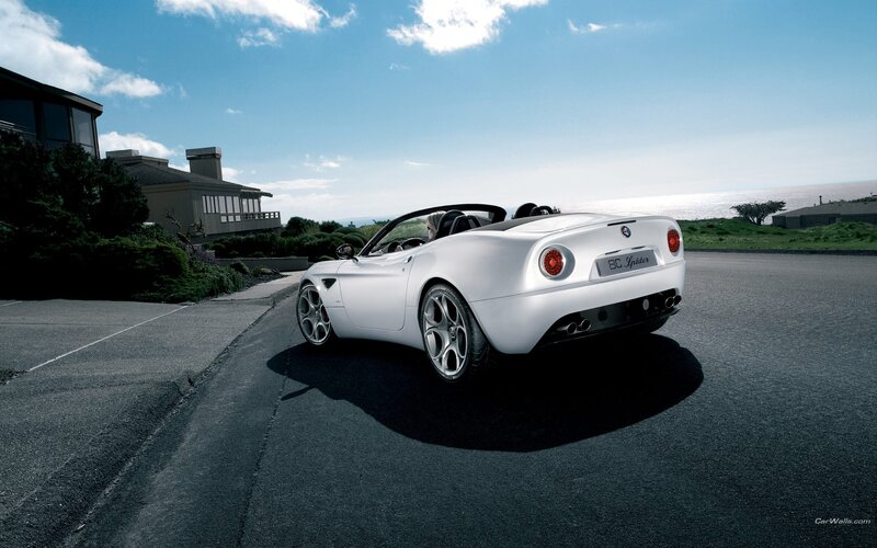 White Alfa Romeo Spider on coastal road