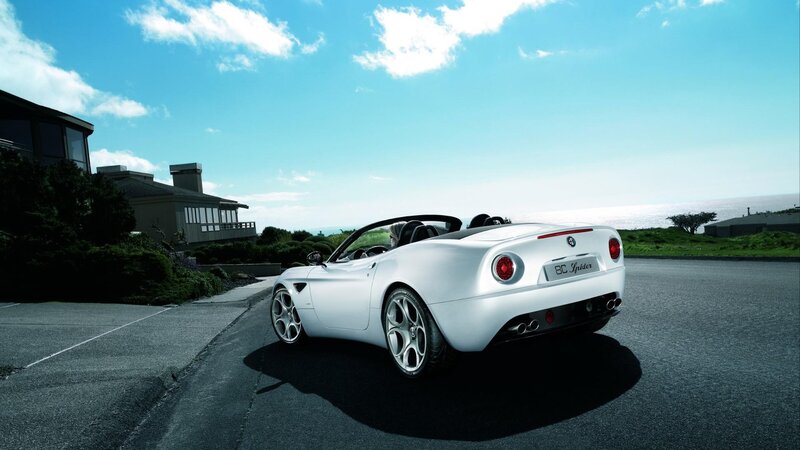 White Alfa Romeo Spider on coastal road
