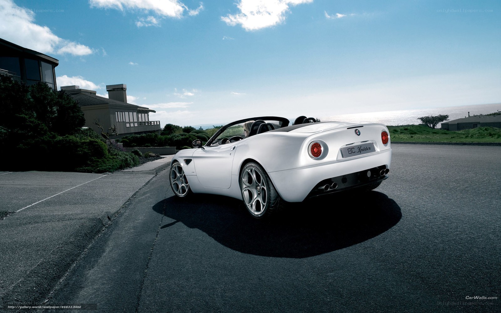 White Alfa Romeo Spider on coastal road
