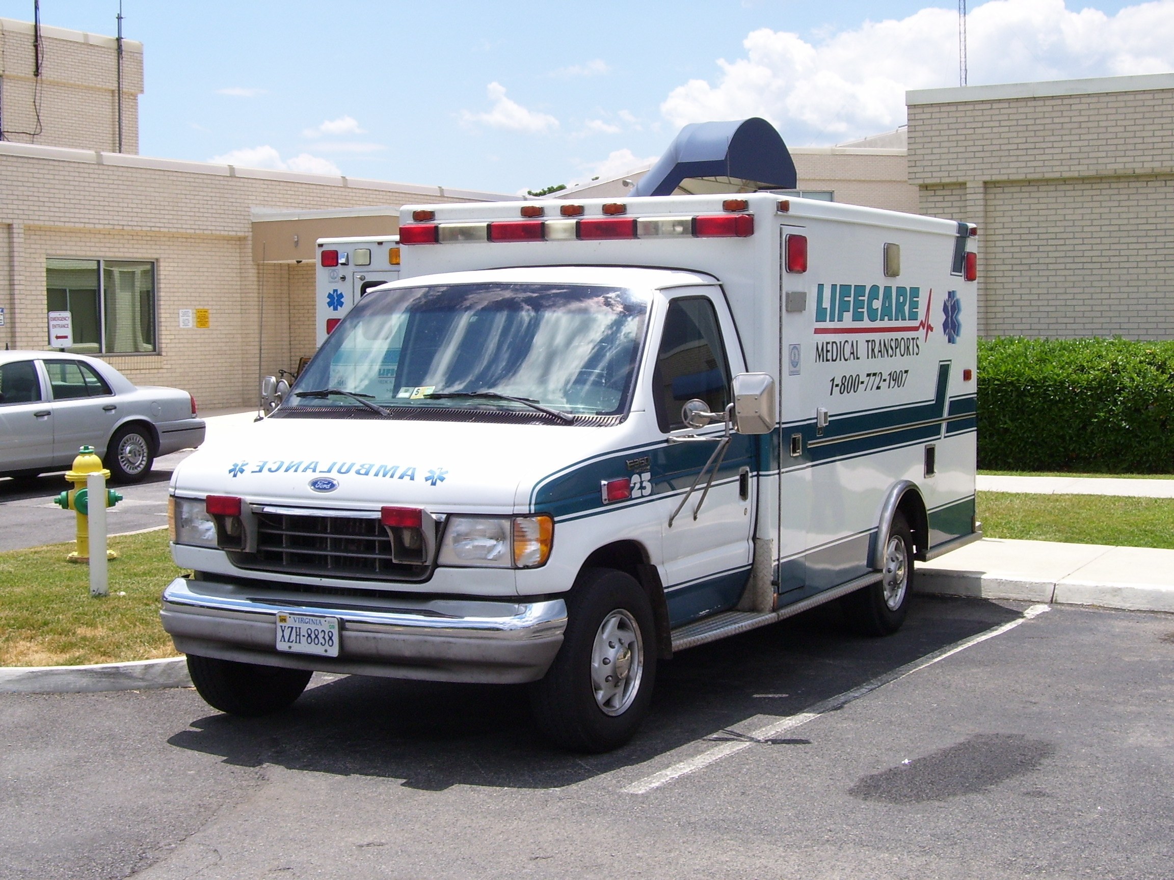 White ambulance parked outside building