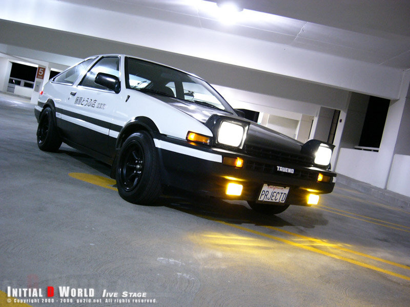white and black AE86 in parking garage