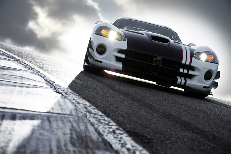 White and black sports car on track