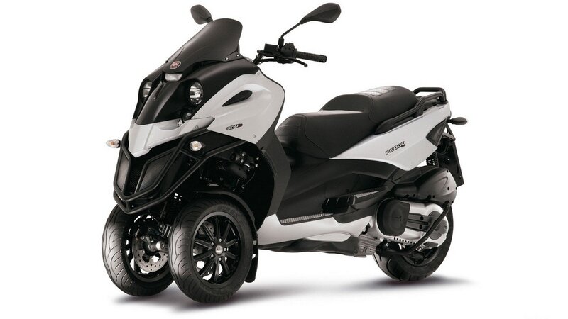 white and black three-wheeled scooter