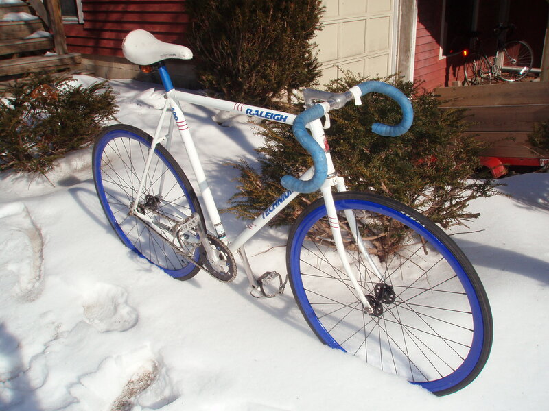 White and blue bicycle in snow