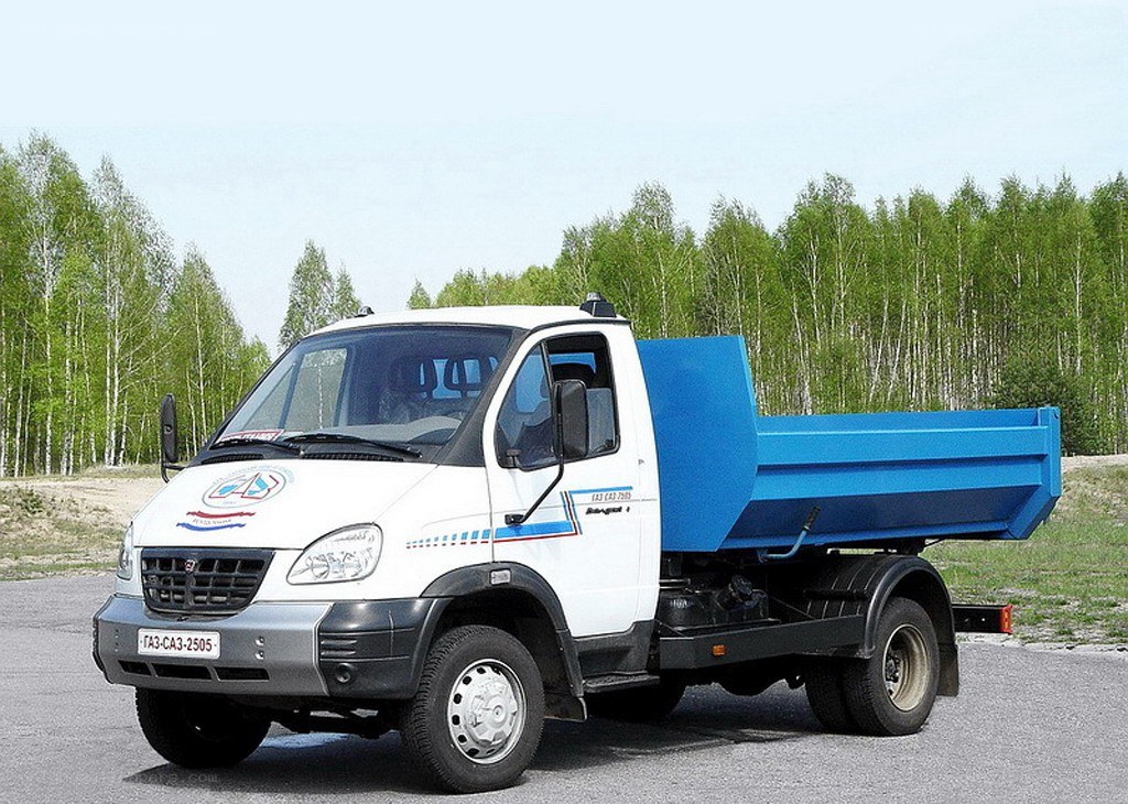 white and blue dump truck