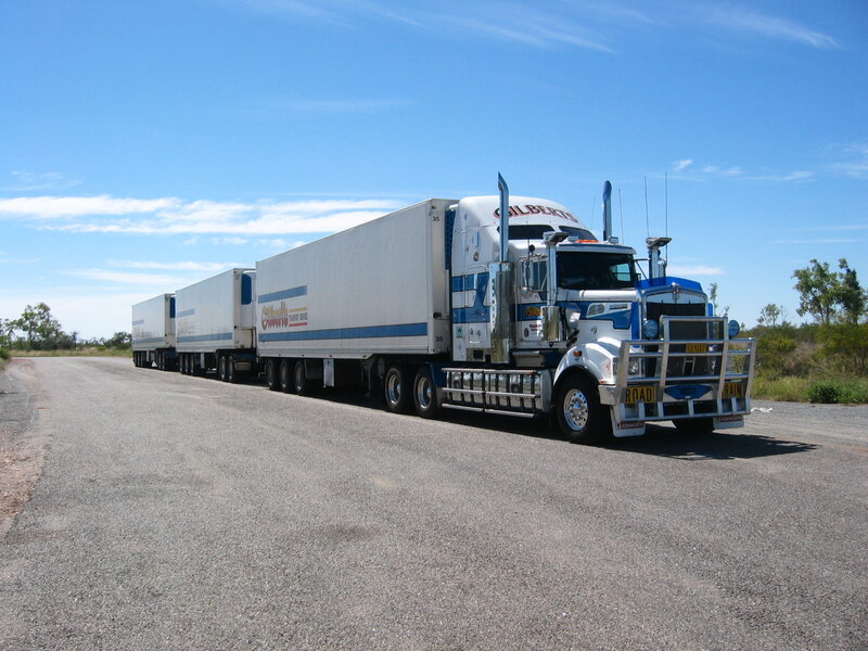 White and blue semi-truck on road