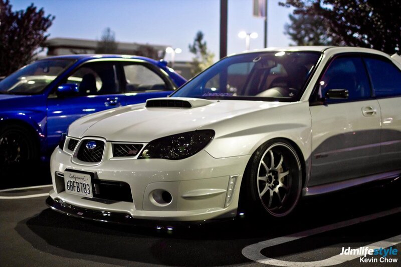 White and blue Subaru cars