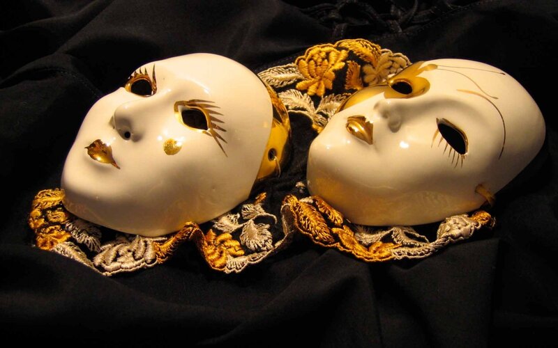 white and gold masks on black fabric