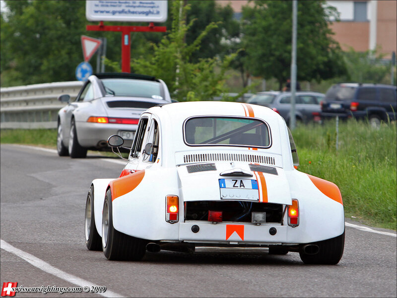 White and orange race car on road