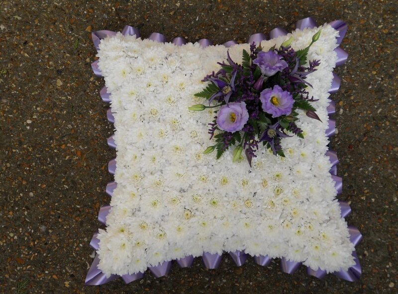 white and purple floral pillow