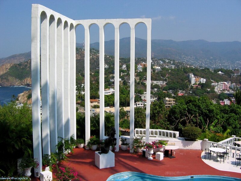 White arches overlooking a coastal city