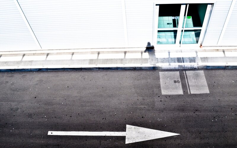 White arrow on asphalt road