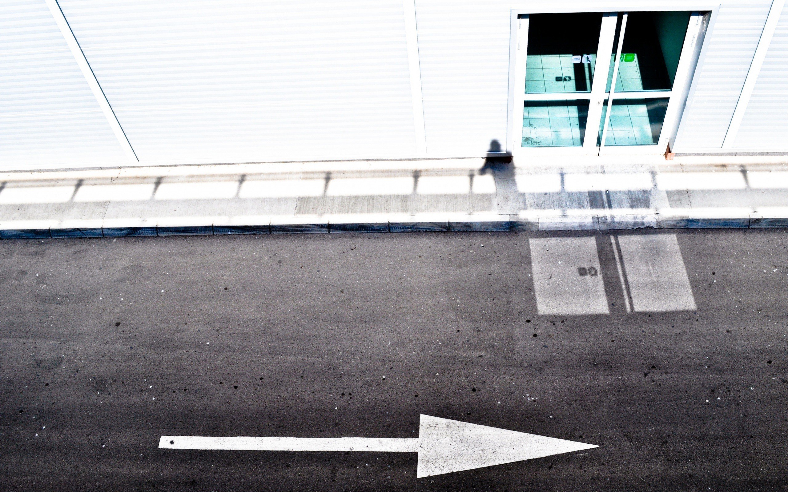 White arrow on asphalt road