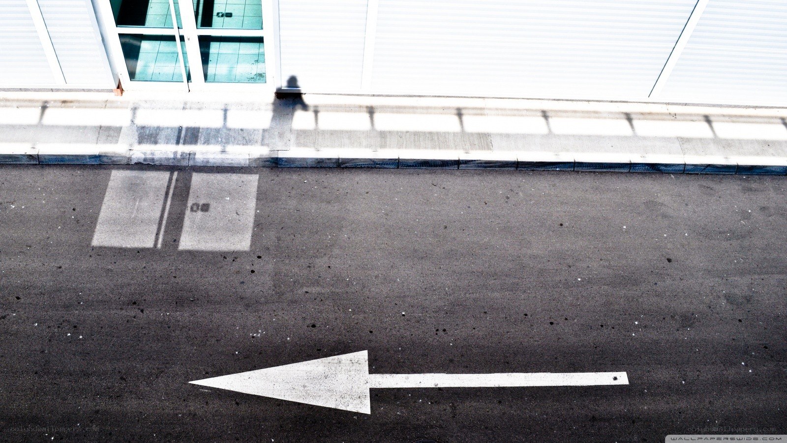 White arrow on asphalt street