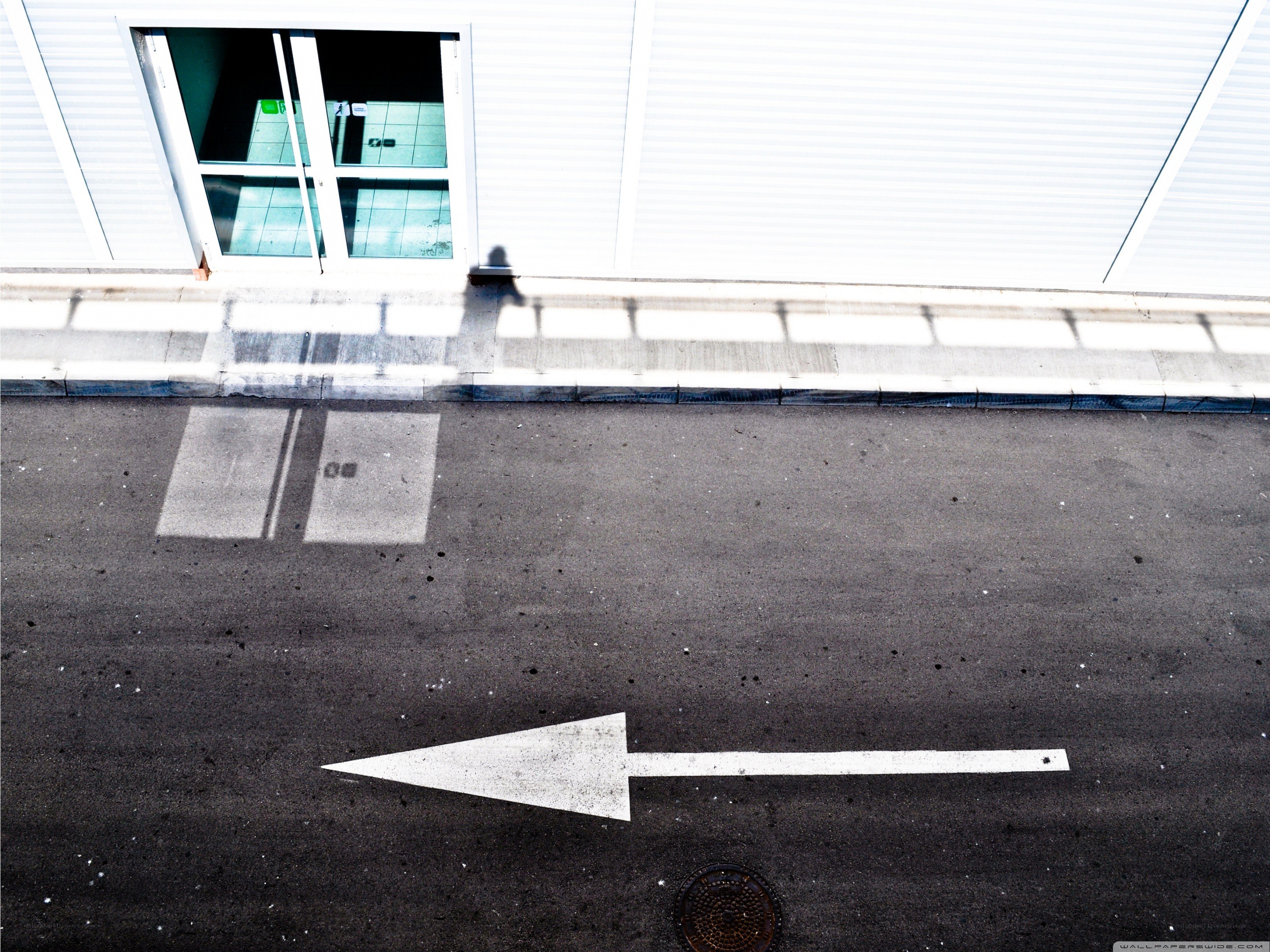 White arrow on asphalt street