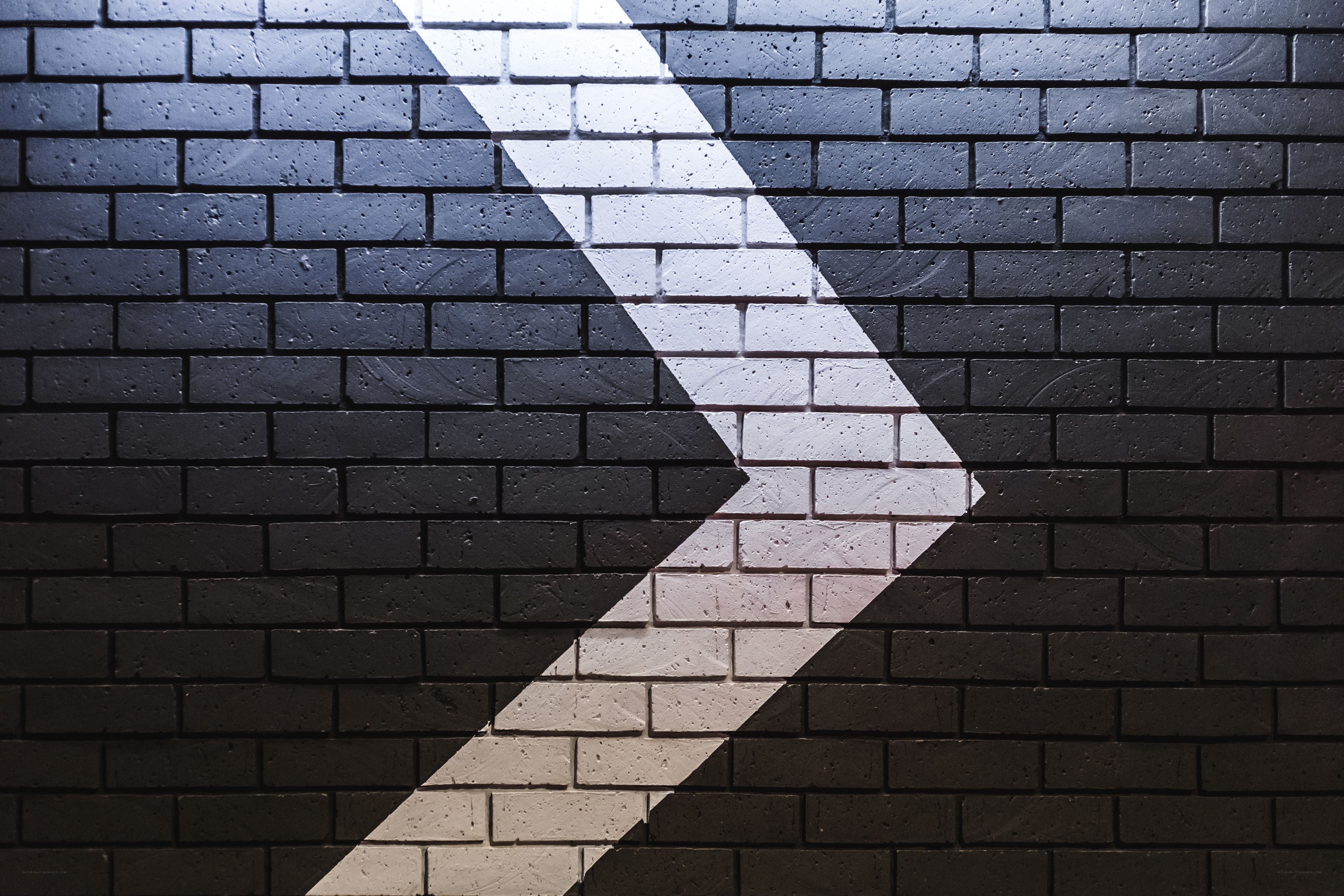 White arrow on brick wall