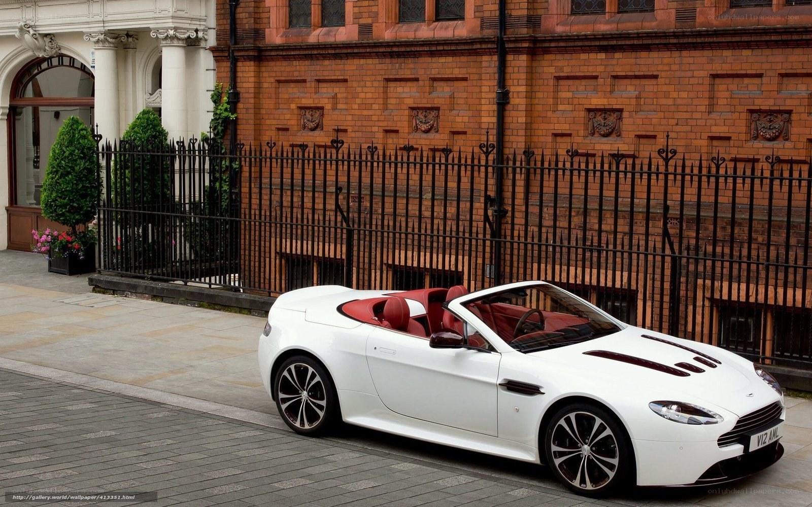 White Aston convertible on city street