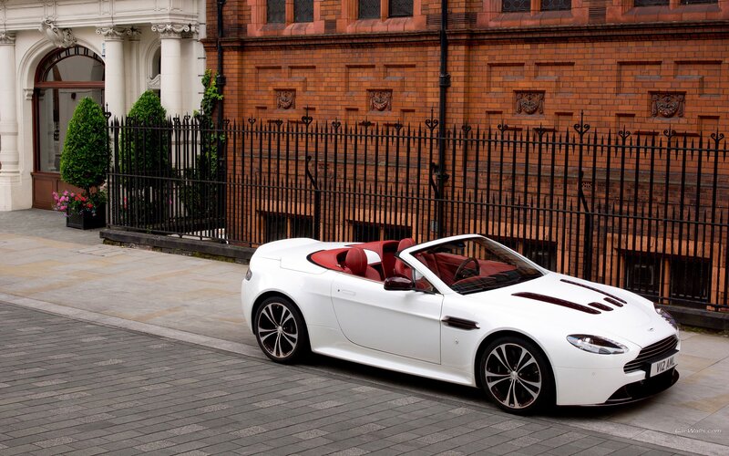 White Aston convertible on city street
