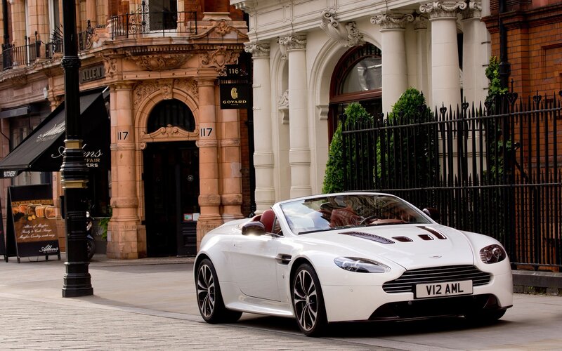 White Aston convertible on city street