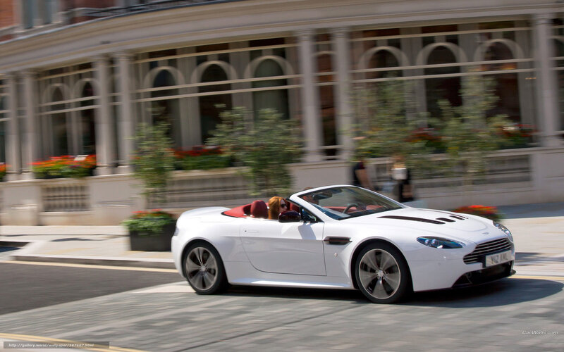 White Aston convertible on city street