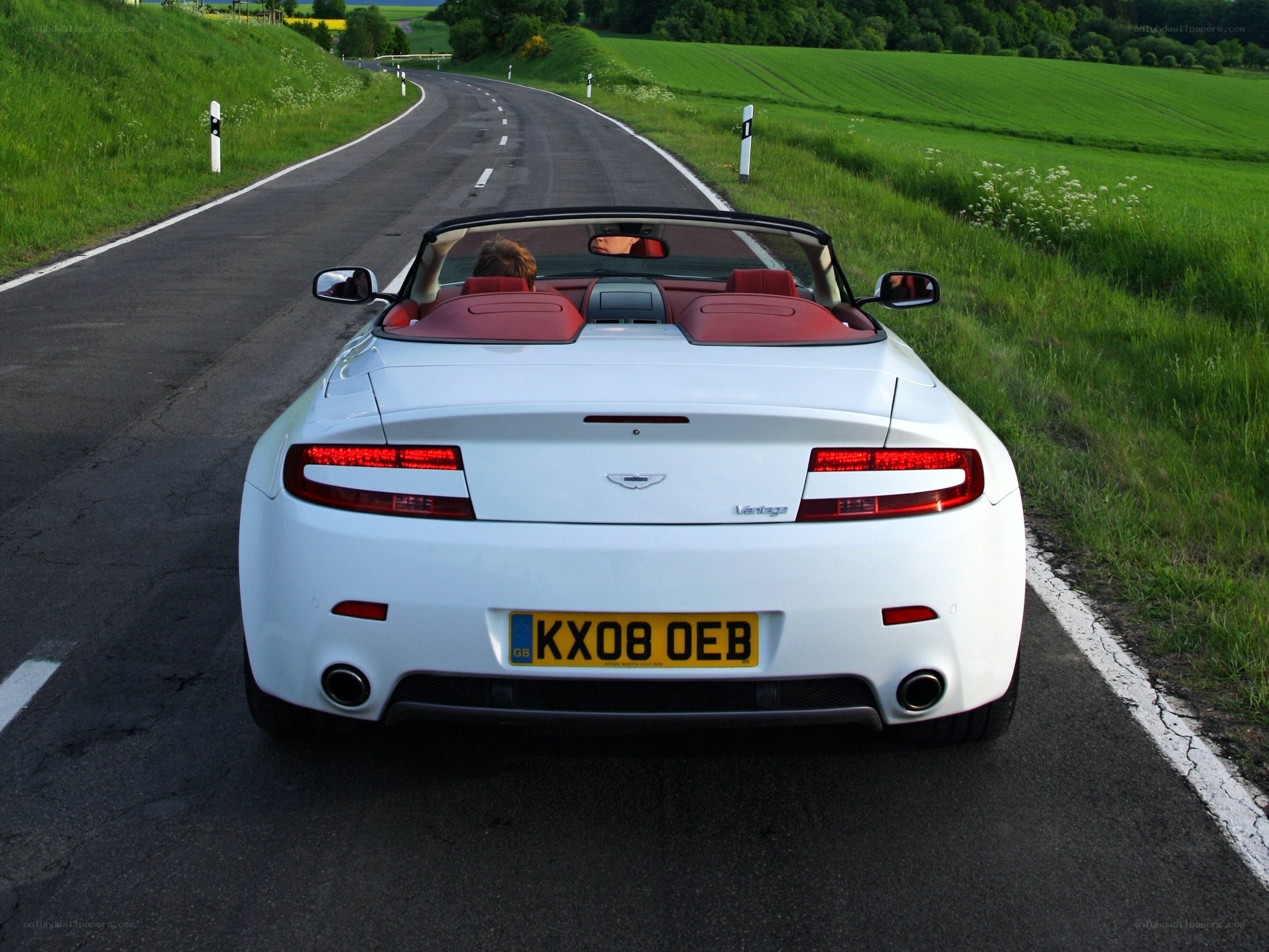 White Aston convertible on country road